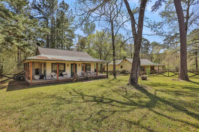 a front view of a house with yard porch and furniture
