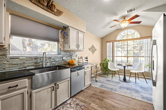 a kitchen with sink cabinets and dining table