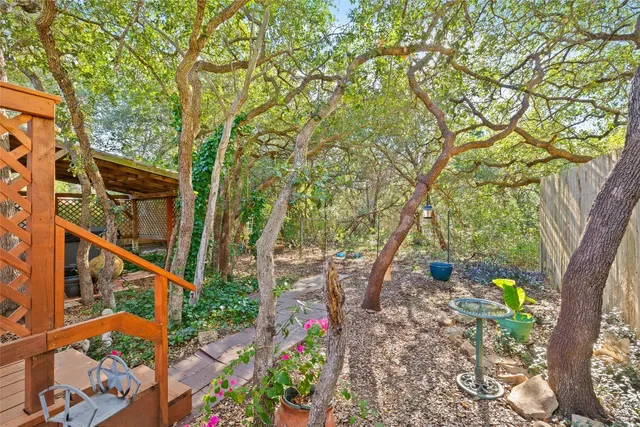 a backyard of a house with lots of green space and trees