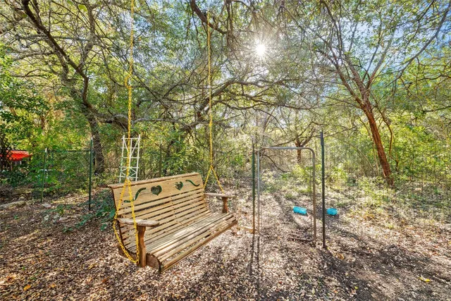 a view of a bench in a backyard