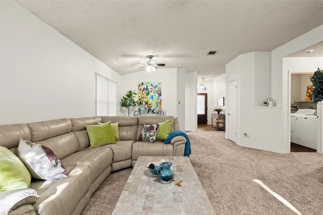 a living room with furniture and a rug
