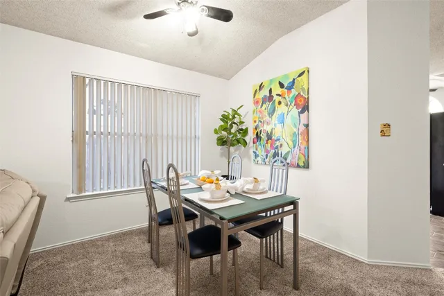 a view of a dining room with furniture and a potted plant