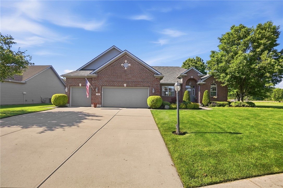 710 Governors Road Troy, OH 45373 - Photo 3 of 56 This beautiful brick home features a well-manicured lawn and a spacious concrete driveway.
