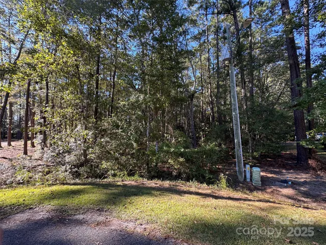 a view of a swimming pool with lawn chairs under an umbrella