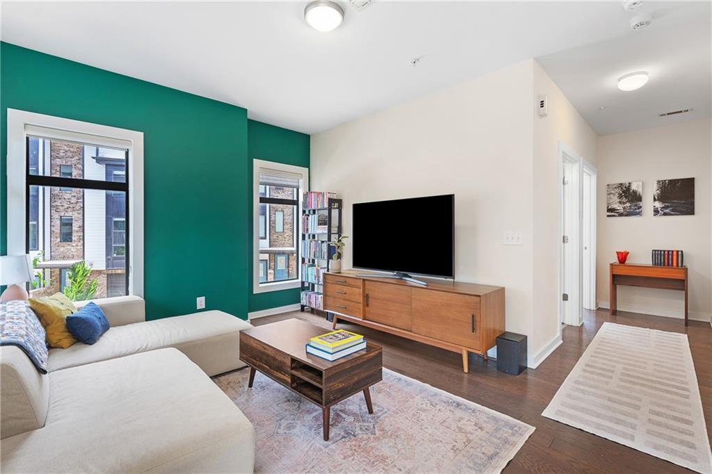 a living room with furniture and a flat screen tv