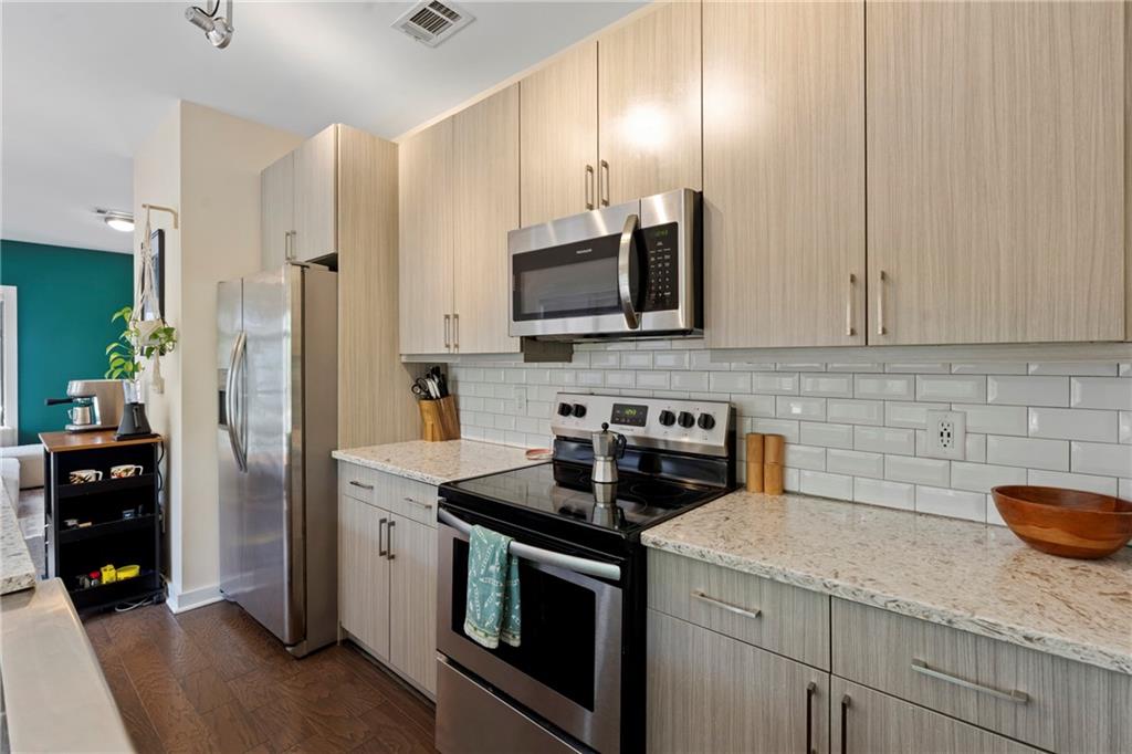 46 Moda Lane Atlanta, GA 30307 - Photo 17 of 31 a kitchen with stainless steel appliances granite countertop a stove a refrigerator and a stove