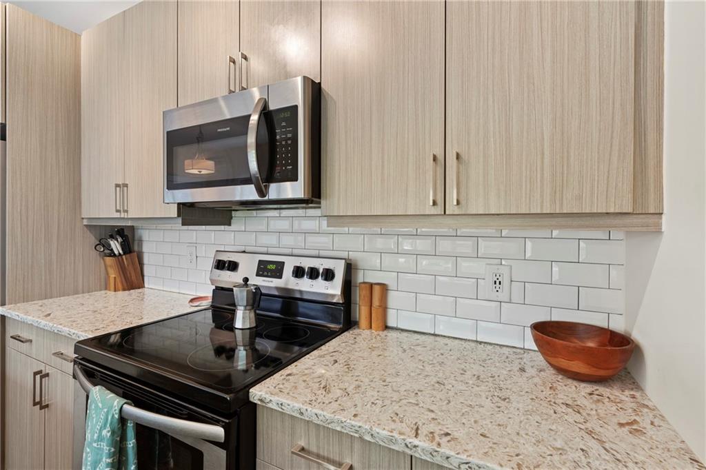 46 Moda Lane Atlanta, GA 30307 - Photo 20 of 31 a kitchen with granite countertop a stove sink and cabinets
