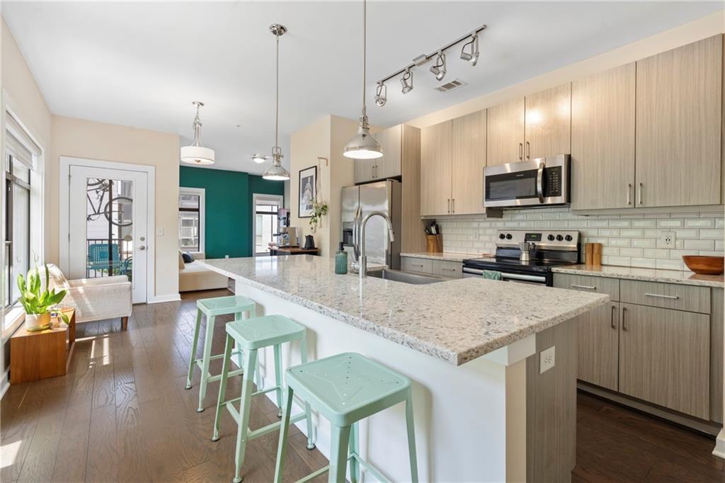 46 Moda Lane Atlanta, GA 30307 - Photo 2 of 31 a kitchen with a sink a counter top space appliances and cabinets