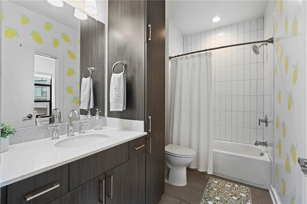 46 Moda Lane Atlanta, GA 30307 - Photo 10 of 31 a bathroom with a sink a toilet and shower