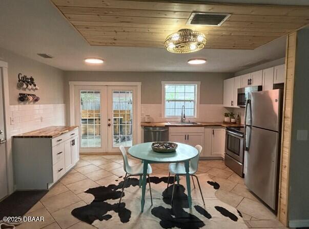 1025 2nd Street Port Orange, FL 32129 - Photo 11 of 33 a kitchen with stainless steel appliances a dining table and chairs