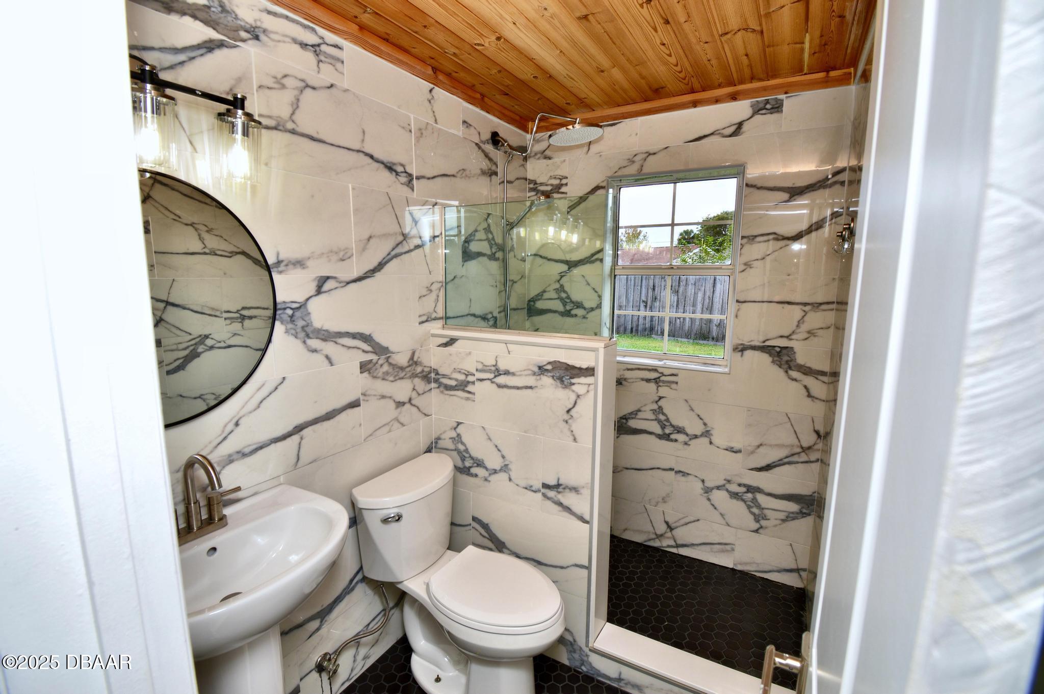 1025 2nd Street Port Orange, FL 32129 - Photo 12 of 33 a bathroom with a toilet and a shower
