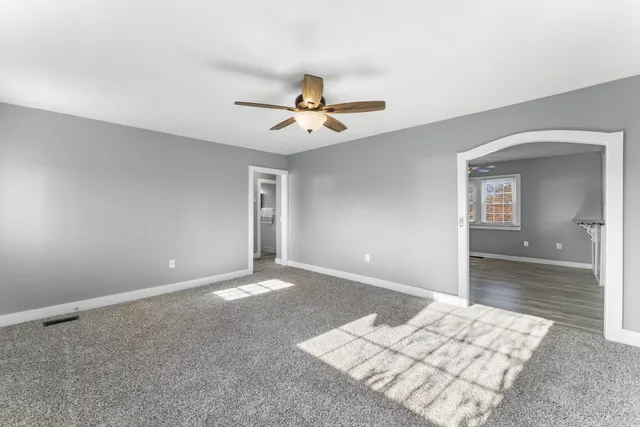 a view of a kitchen with wooden floor and a kitchen space