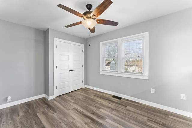 a kitchen with granite countertop a stove sink and refrigerator