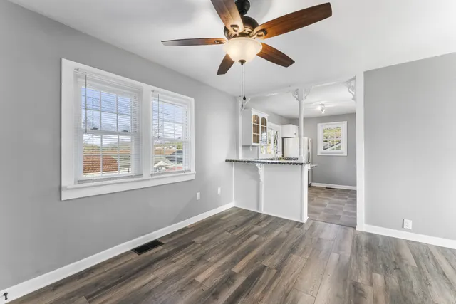 a kitchen with stainless steel appliances granite countertop a stove a sink and a refrigerator with wooden cabinets