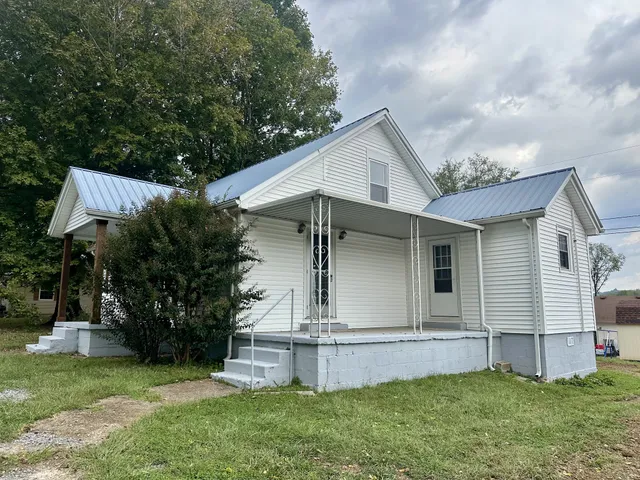 a view of a big room with windows and chandelier fan