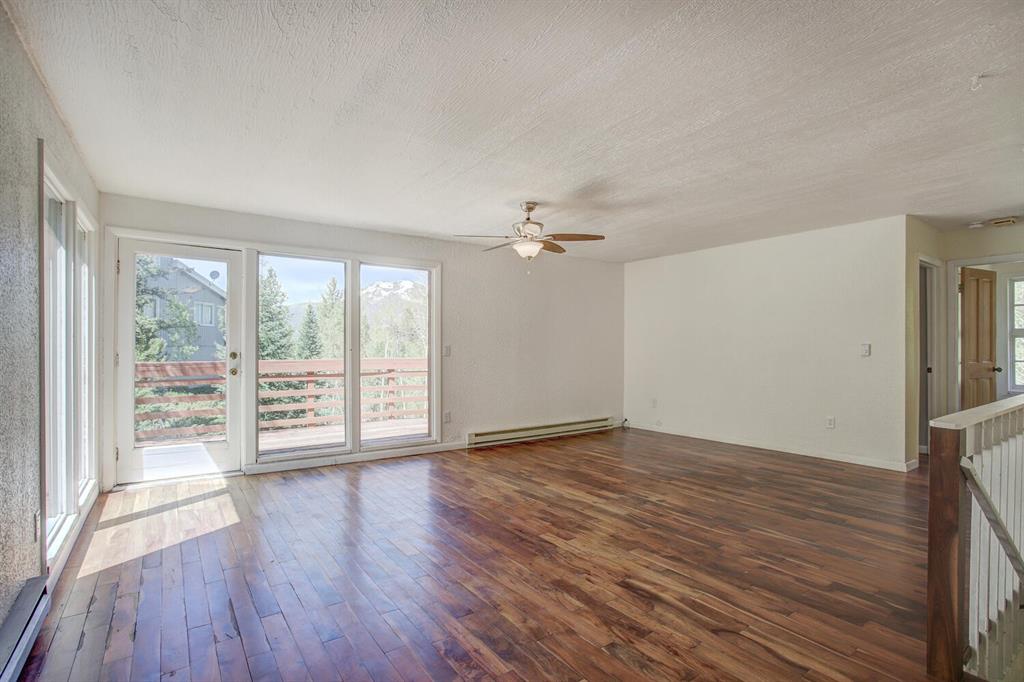 347 Deer Path Road Dillon, CO 80435 - Photo 11 of 26 a view of an empty room with wooden floor and a window