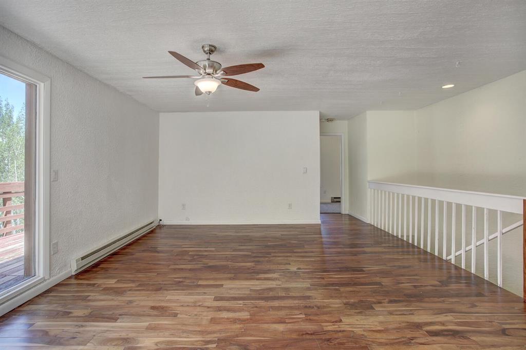 347 Deer Path Road Dillon, CO 80435 - Photo 12 of 26 a view of an empty room with wooden floor and a window