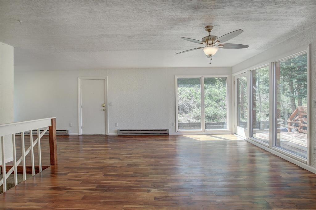 347 Deer Path Road Dillon, CO 80435 - Photo 13 of 26 a view of an empty room with wooden floor and a window