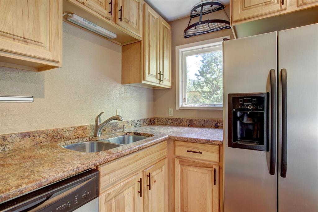 347 Deer Path Road Dillon, CO 80435 - Photo 9 of 26 a kitchen with stainless steel appliances granite countertop a sink a refrigerator and a granite counter tops