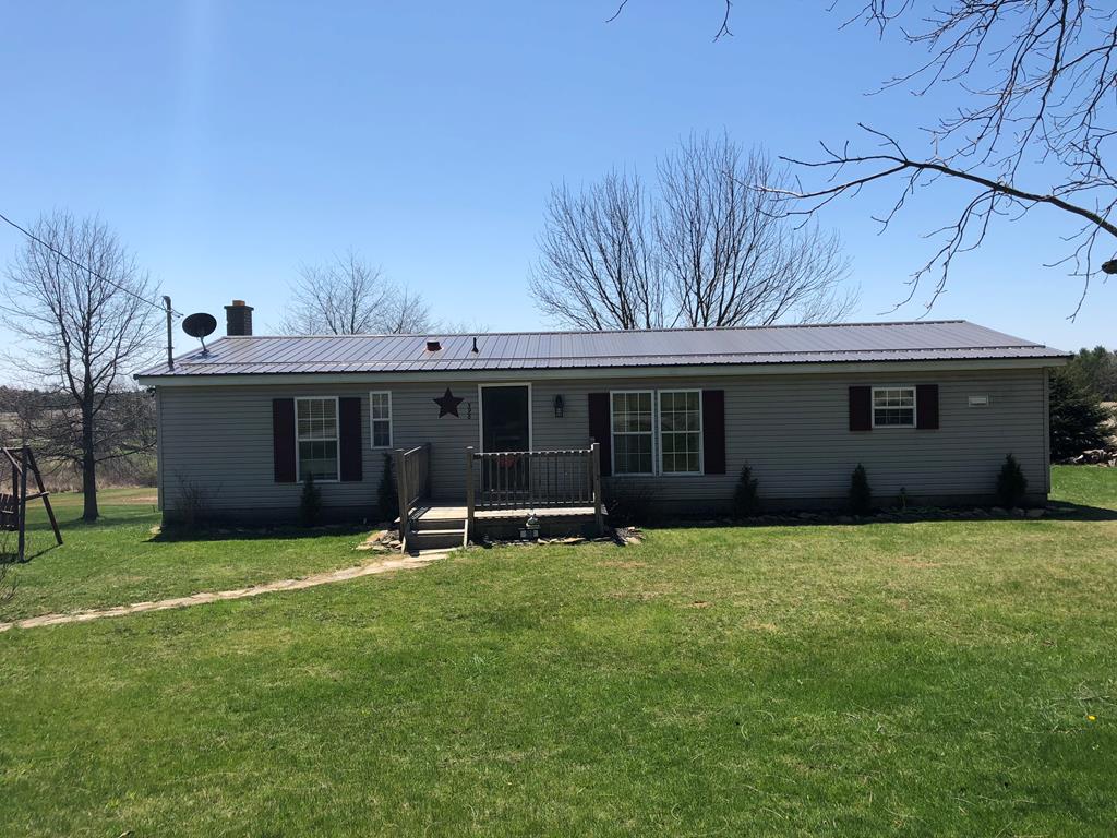598 Maxwell Road Clarion, PA 16214 - Photo 1 of 1 a front view of a house with a yard and garage