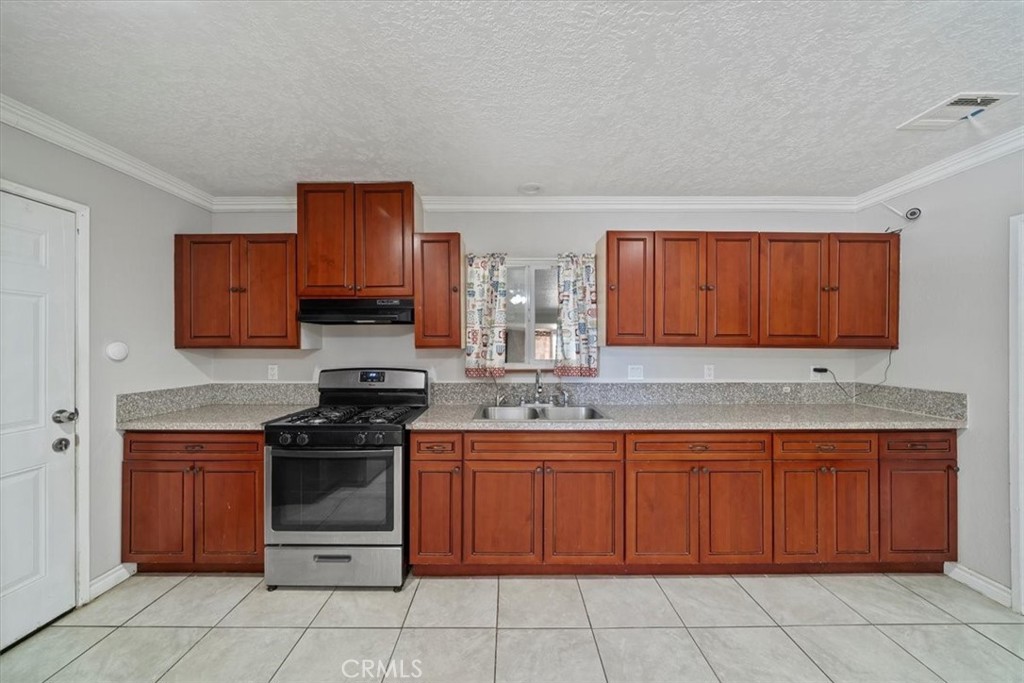 20548 Neuralia Road California City, CA 93505 - Photo 23 of 49 a kitchen with a sink stove top oven and cabinets