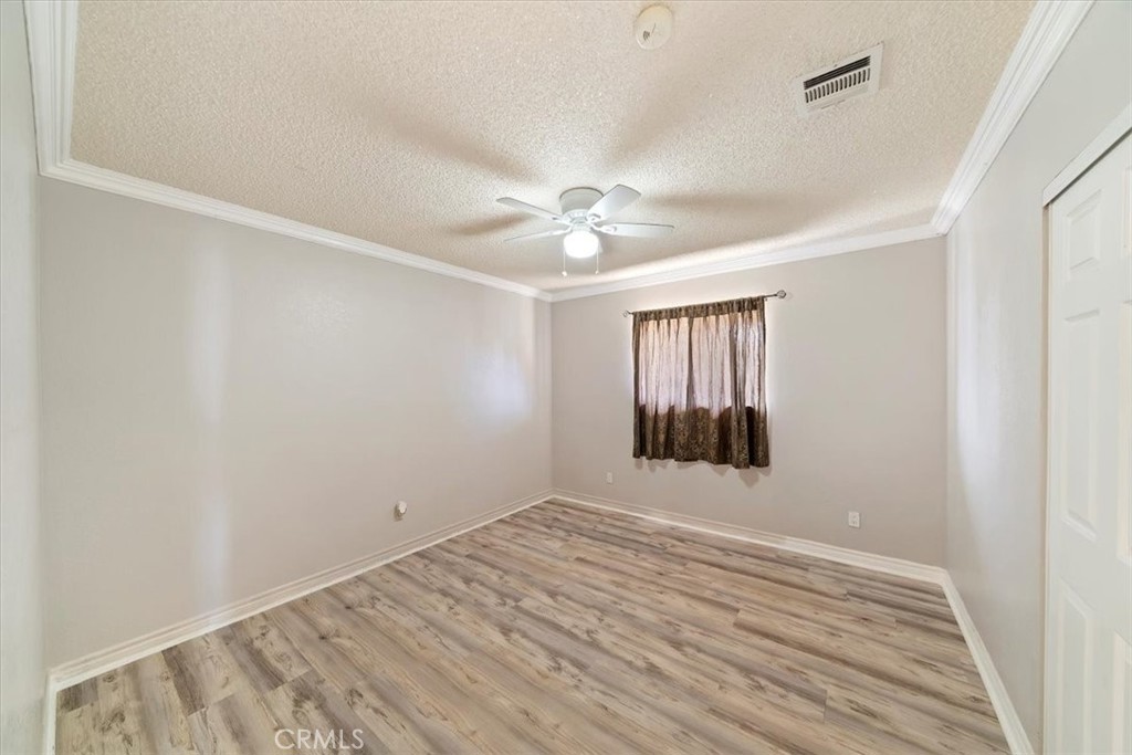 20548 Neuralia Road California City, CA 93505 - Photo 34 of 49 an empty room with windows and fan