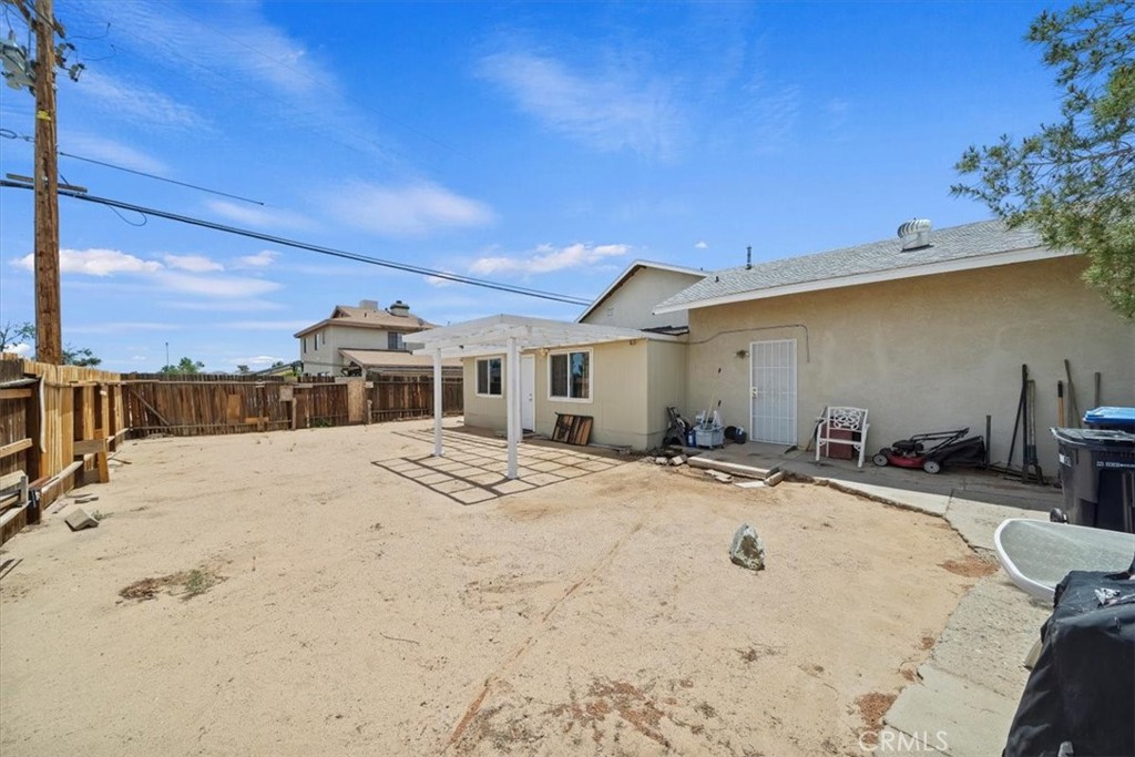 20548 Neuralia Road California City, CA 93505 - Photo 45 of 49 a view of a white house with wooden fence