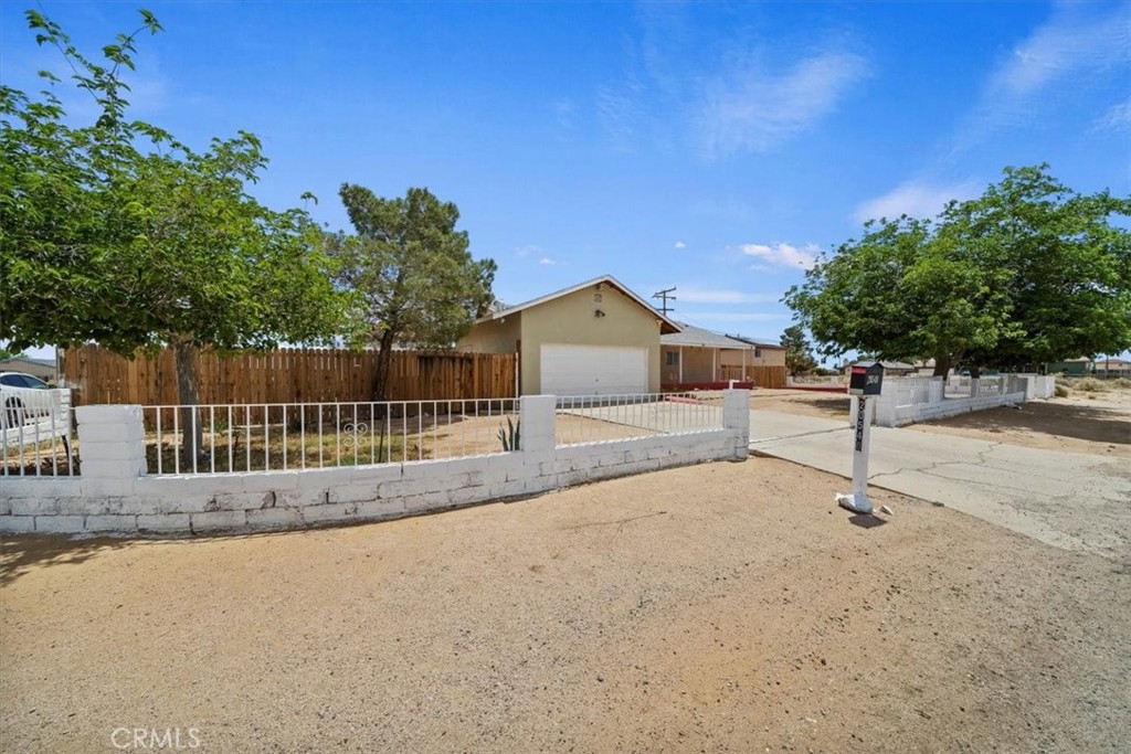 20548 Neuralia Road California City, CA 93505 - Photo 10 of 49 a house with trees in the background