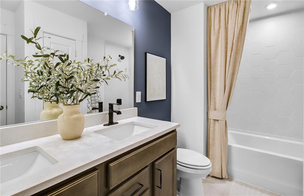 303 Rockledge Bend Southwest Powder Springs, GA 30127 - Photo 17 of 18 a bathroom with a sink a toilet and shower
