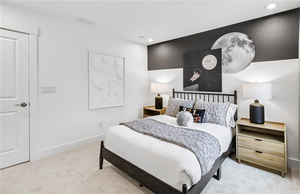 303 Rockledge Bend Southwest Powder Springs, GA 30127 - Photo 18 of 18 a bedroom with a bed and painting on the wall