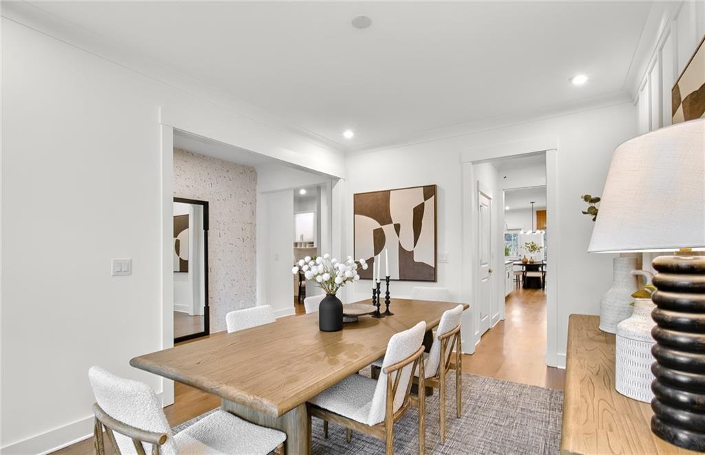303 Rockledge Bend Southwest Powder Springs, GA 30127 - Photo 10 of 18 a view of a dining room with furniture and wooden floor