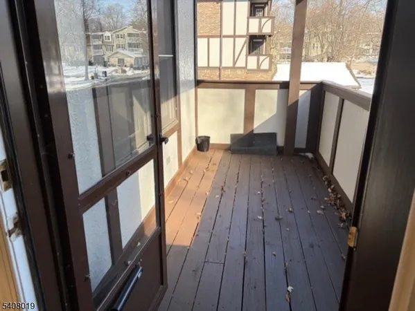 a view of balcony with wooden floor