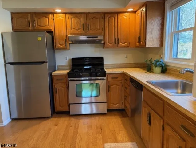 a kitchen with a refrigerator sink and stove
