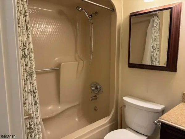 a bathroom with a toilet and shower