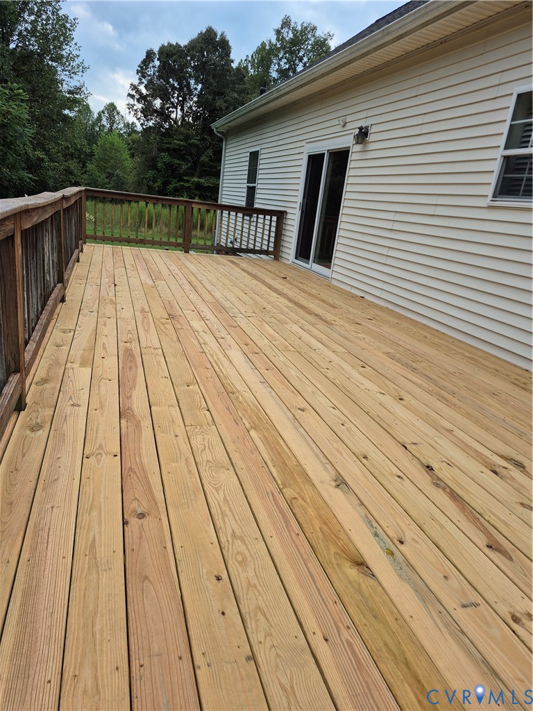 Expansive outdoor deck with natural wood planks, w