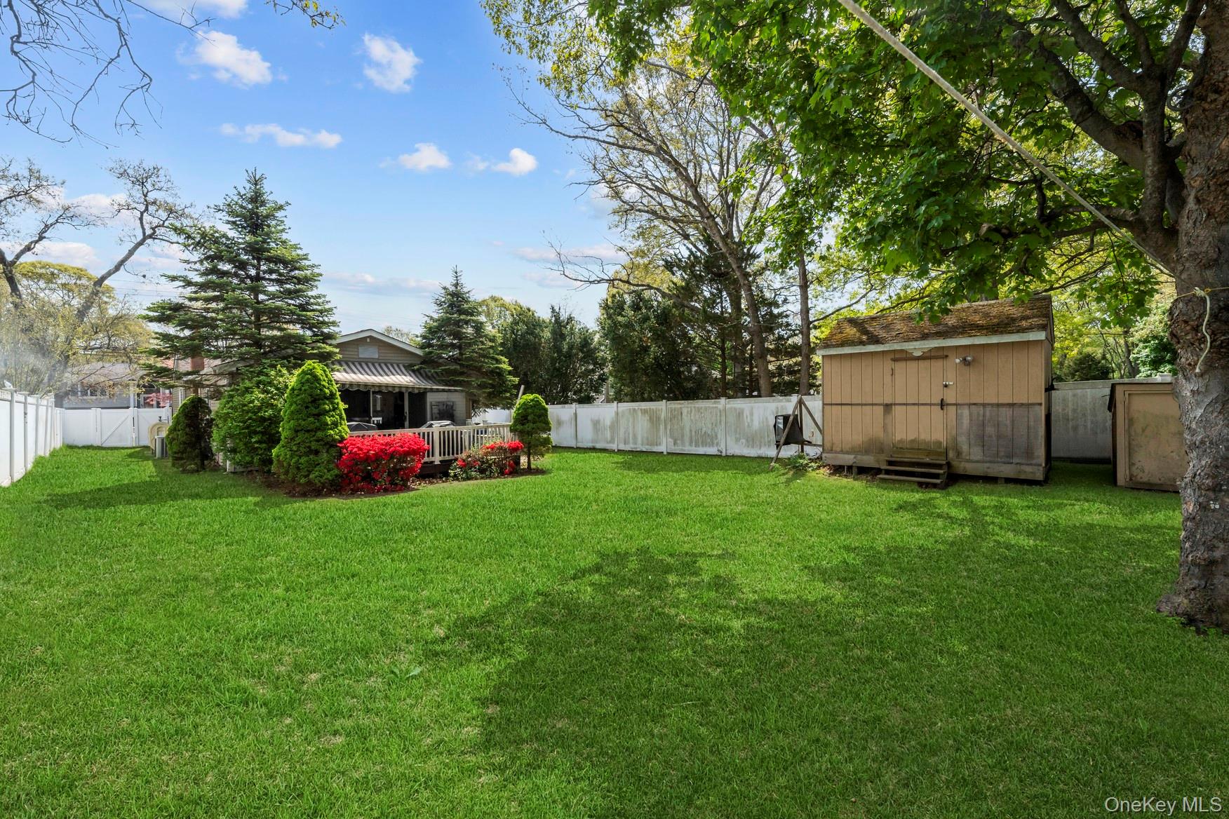 164 Dare Road Selden, NY 11784 - Photo 11 of 20 a view of backyard with garden and trees