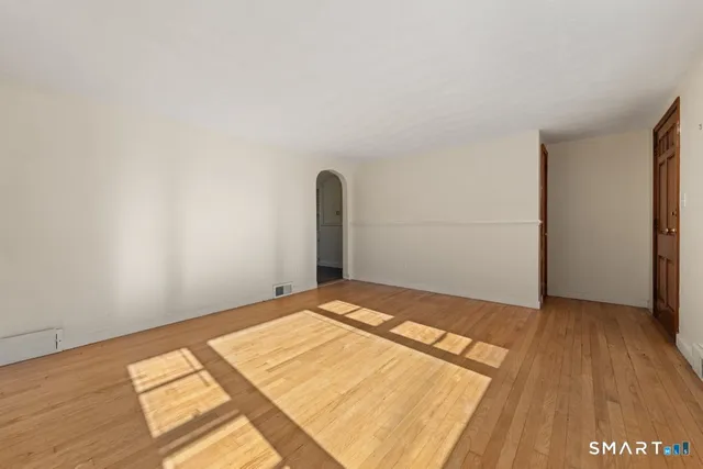 a view of a room with wooden floor