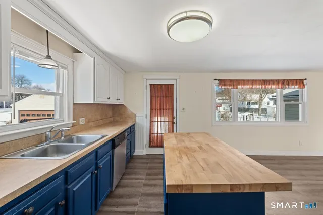 a kitchen with stainless steel appliances granite countertop a sink and a wooden cabinets