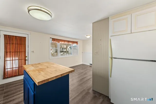 a kitchen with a refrigerator and a stove top oven