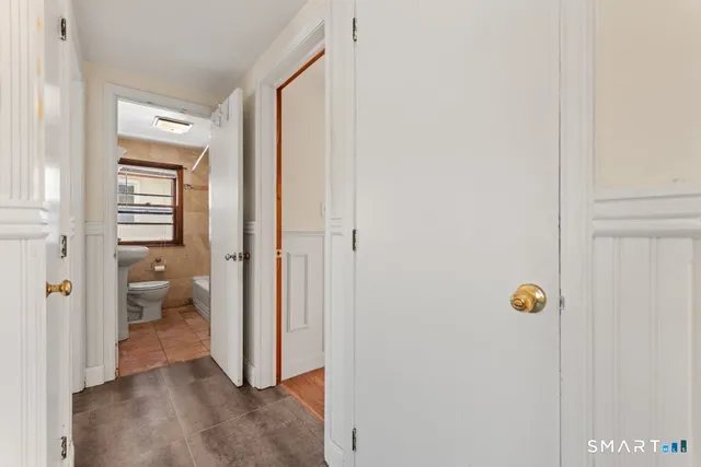 a view of a hallway with closet and a livingroom view