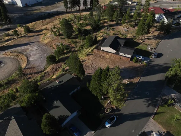 an aerial view of a house with a yard