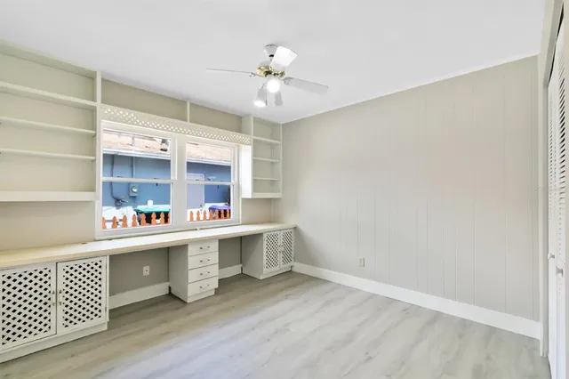 a kitchen with a wooden floor and window