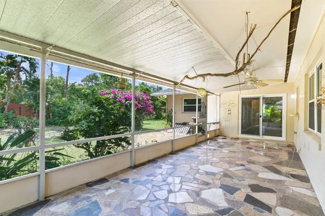 a view of a house with a big yard and potted plants