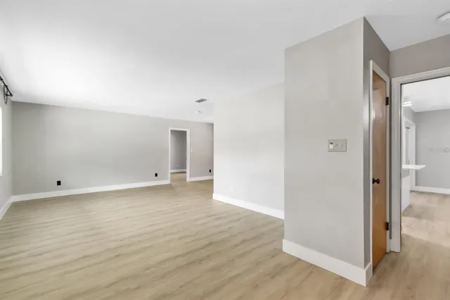 a view of a room with wooden floor