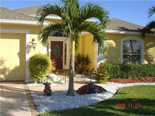 2531 Northwest Windemere Drive Stuart, FL 34994 - Photo 1 of 16 a front view of a house with a yard