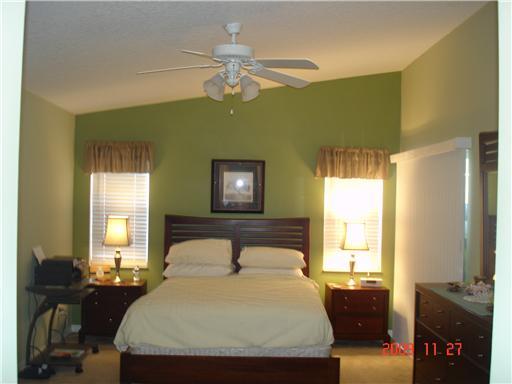 2531 Northwest Windemere Drive Stuart, FL 34994 - Photo 12 of 16 a bedroom with a bed and wooden floor