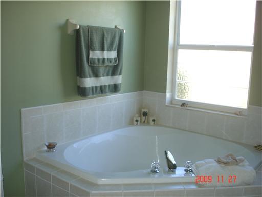 2531 Northwest Windemere Drive Stuart, FL 34994 - Photo 13 of 16 a bath tub sitting in a bathroom next to a window