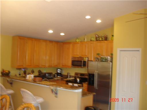 2531 Northwest Windemere Drive Stuart, FL 34994 - Photo 5 of 16 a room with a sink a desk and chairs