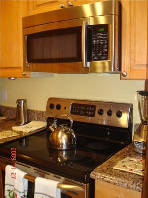 2531 Northwest Windemere Drive Stuart, FL 34994 - Photo 6 of 16 a close view of a stove a microwave and a table
