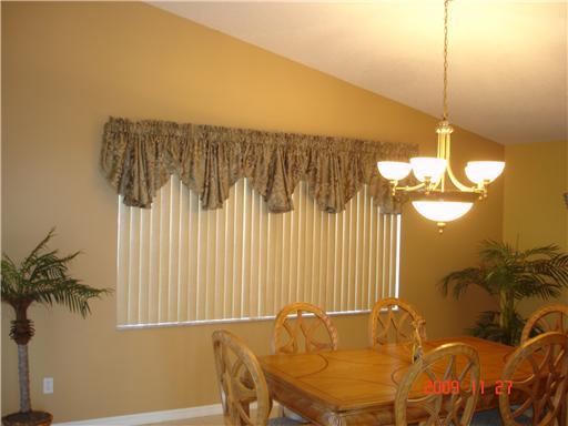 2531 Northwest Windemere Drive Stuart, FL 34994 - Photo 9 of 16 a view of a dining room with furniture and a chandelier